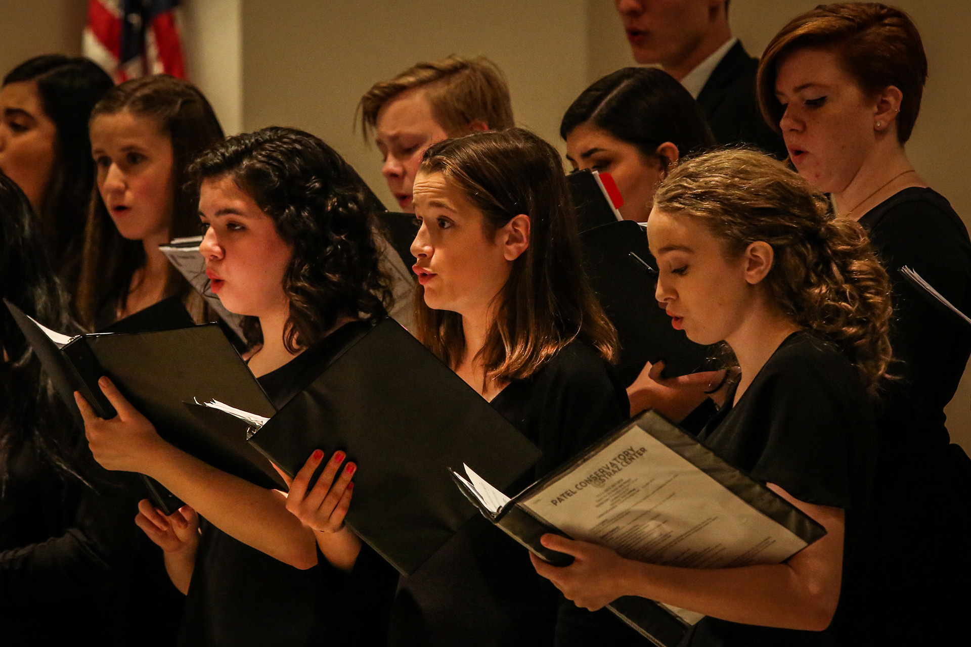 Patel student choir performing in black attire.