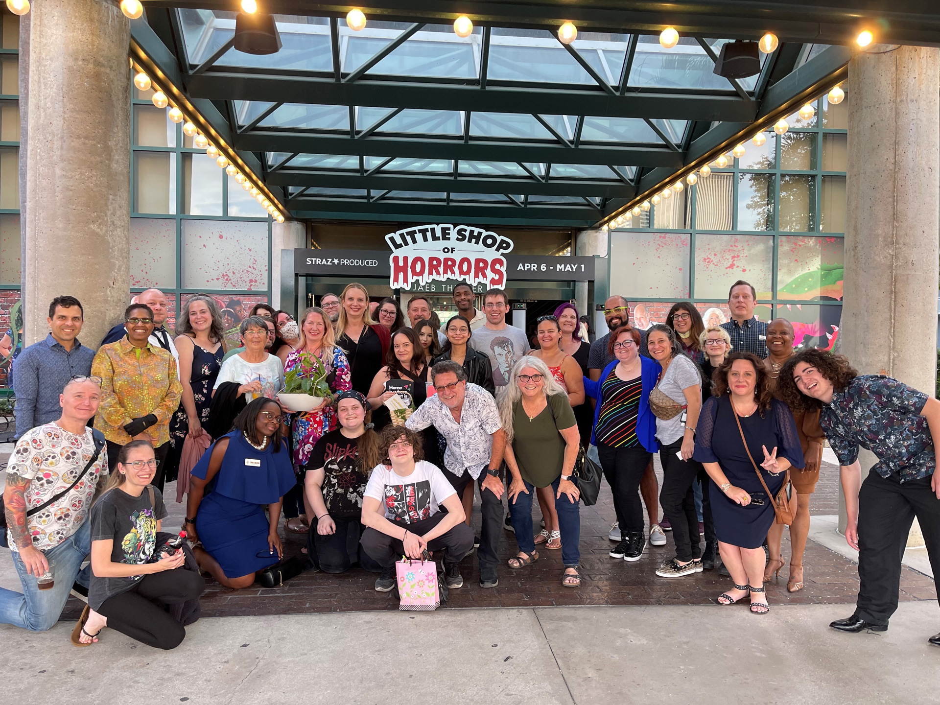 A photo of group of friends in front of the Jaeb Theater