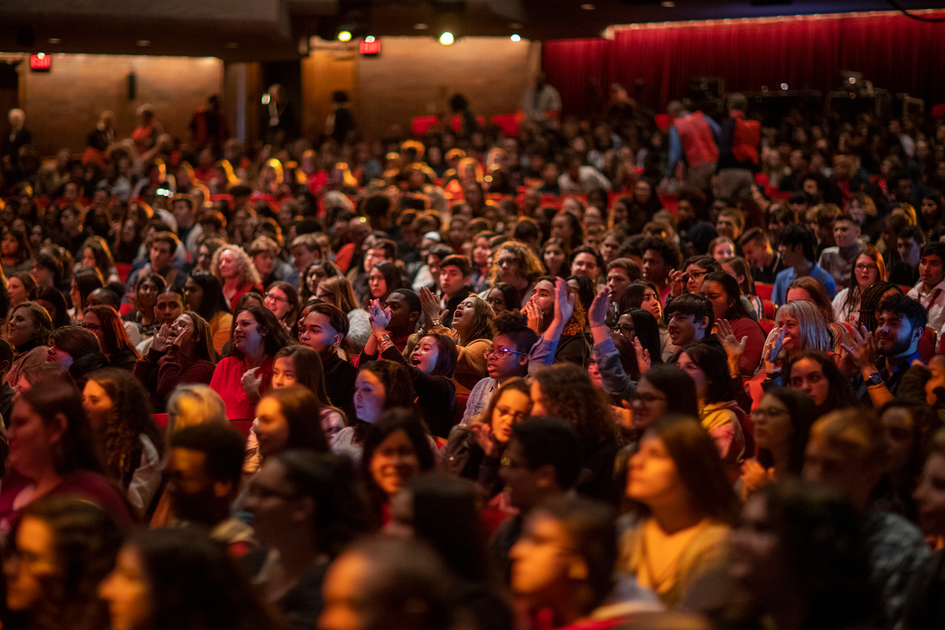 audiences seating down and watching a show in Morsani Hall