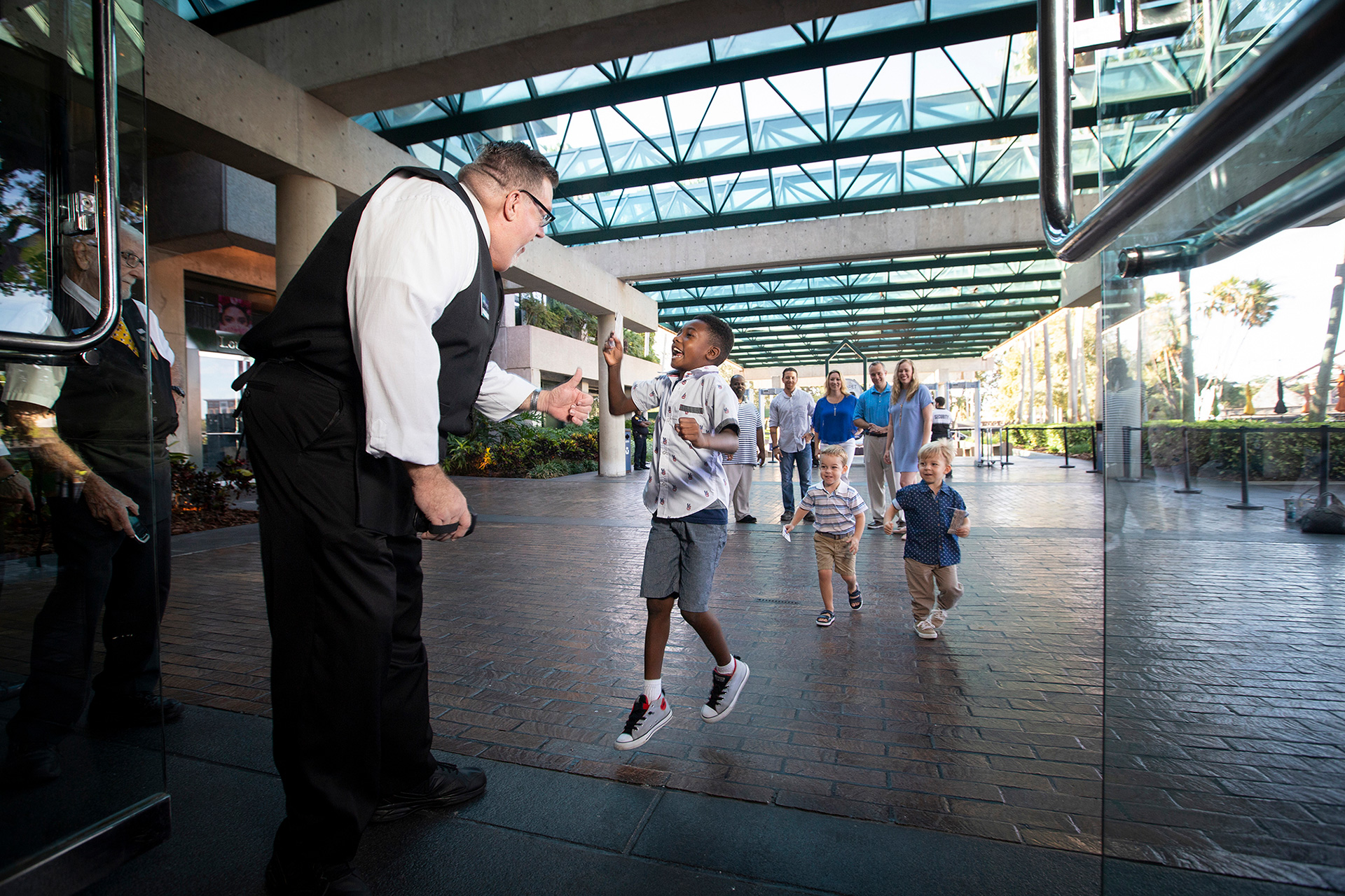 Straz usher greeting guests at the entrance to Morsani Hall.