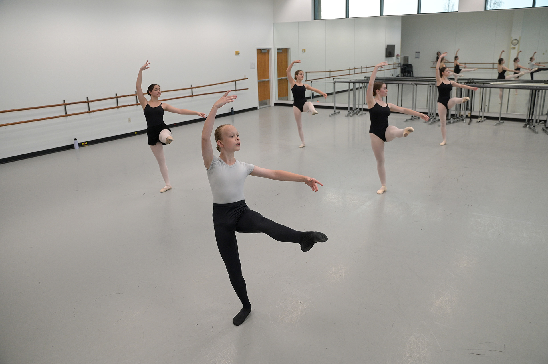 Ballet students practicing in a dance studio.