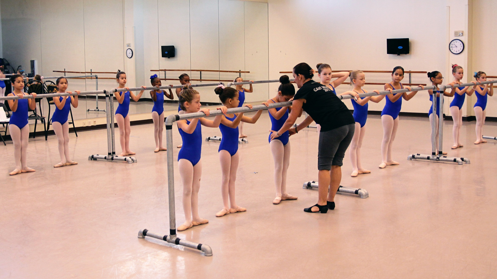 Patel instructor teaching ballet students in a studio.