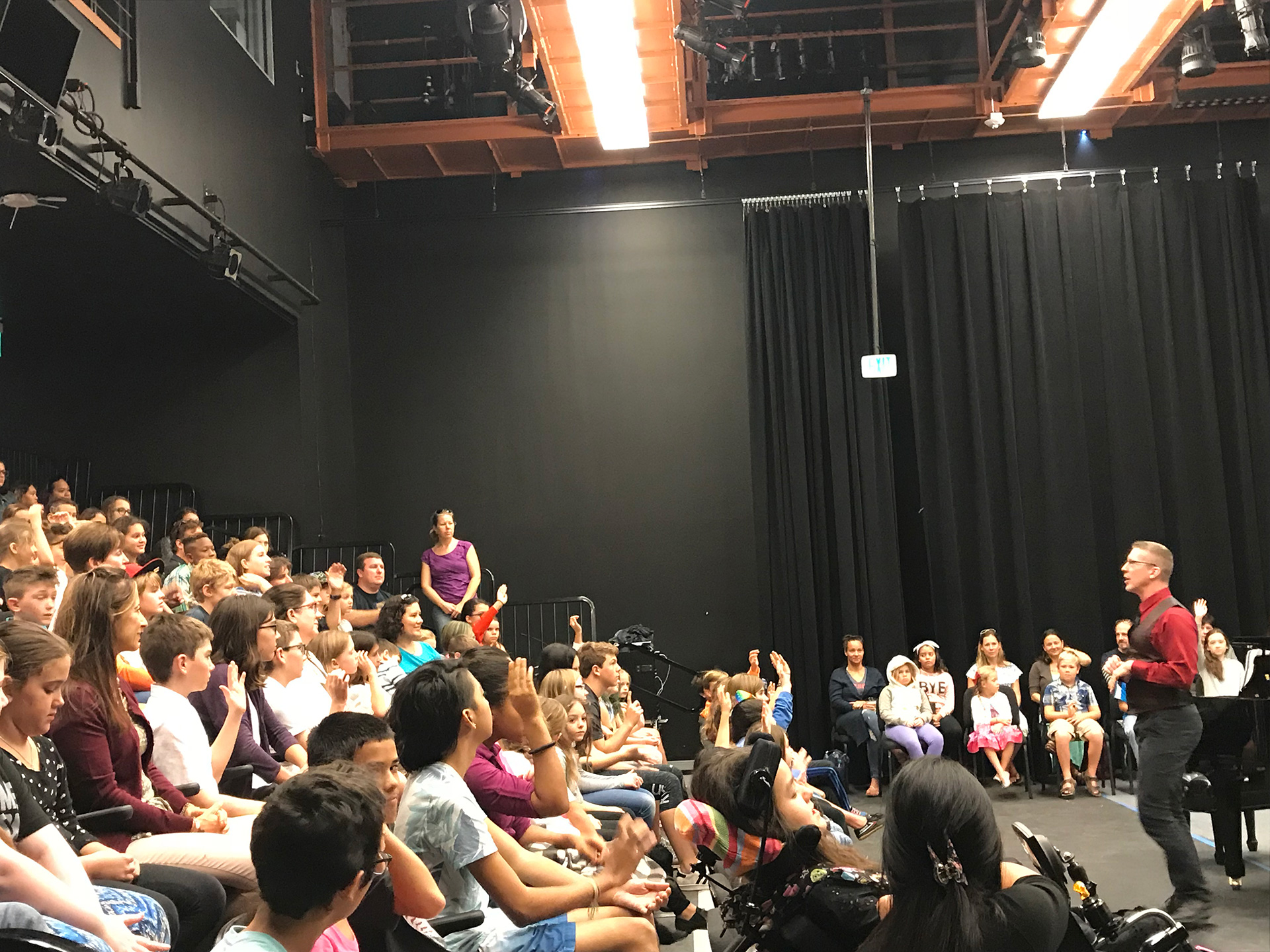 students sitting down and listening to teacher in a masterclass