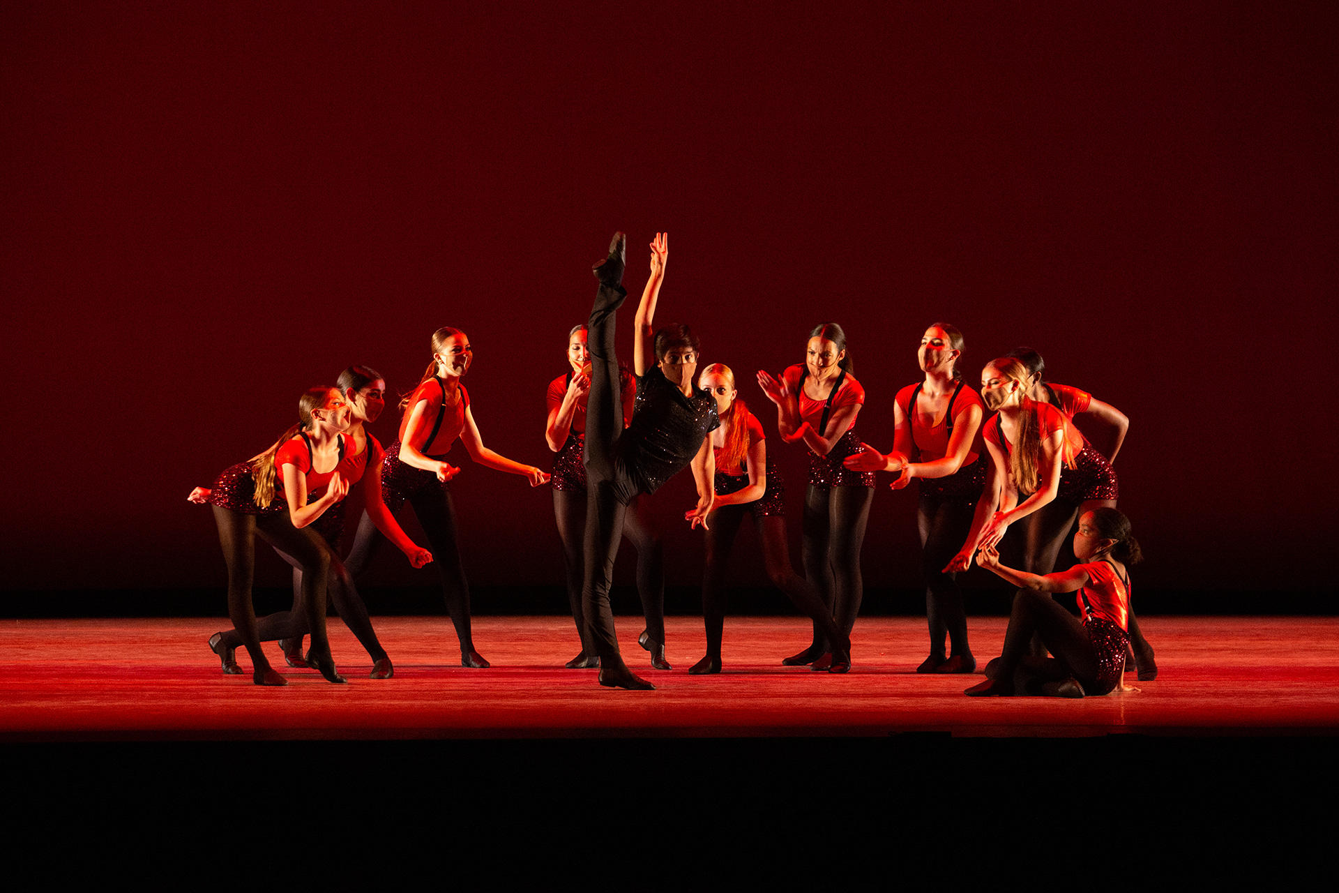Patel students performing on stage in costume.