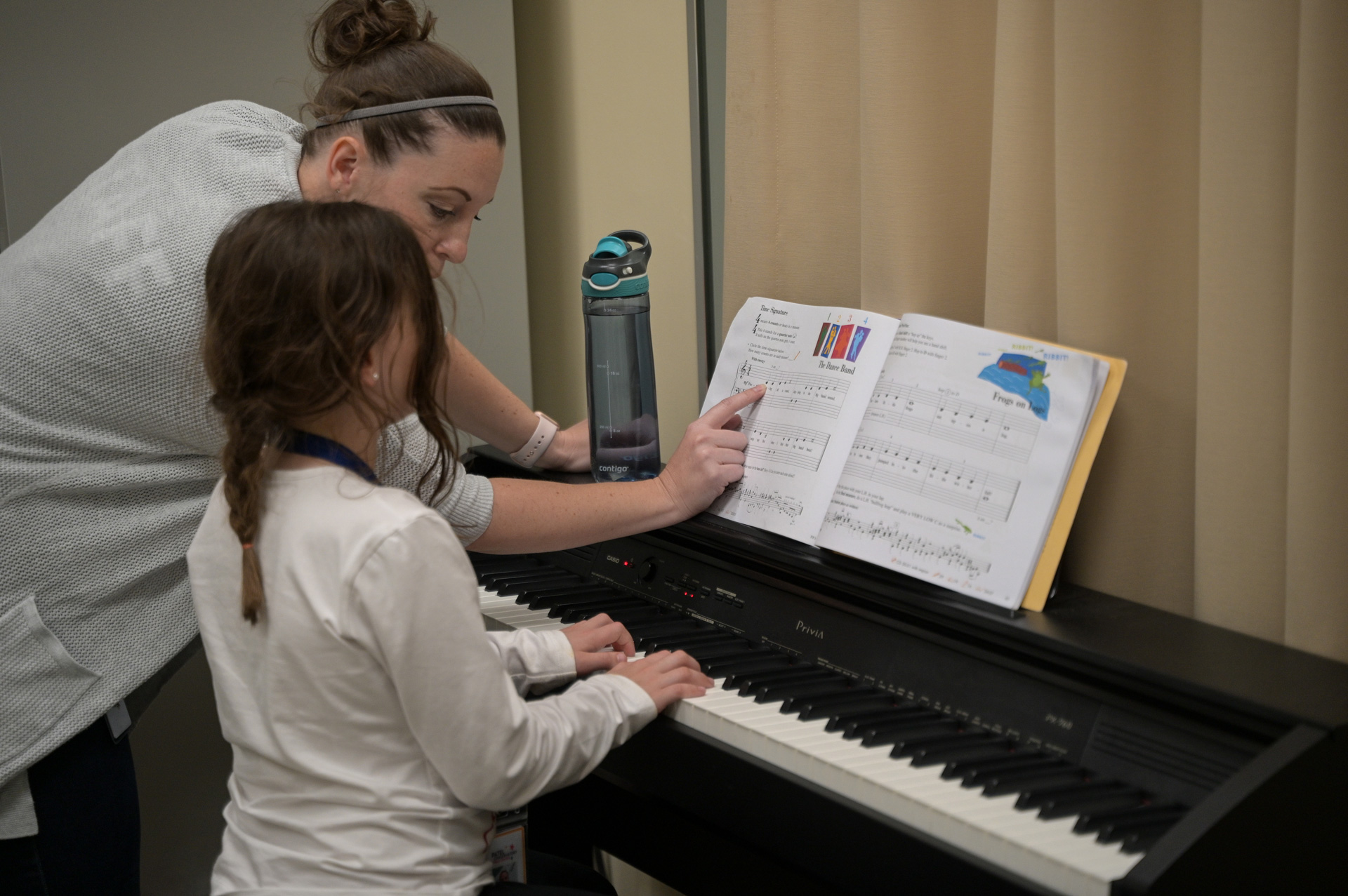 Patel instructor teaching piano to a student.