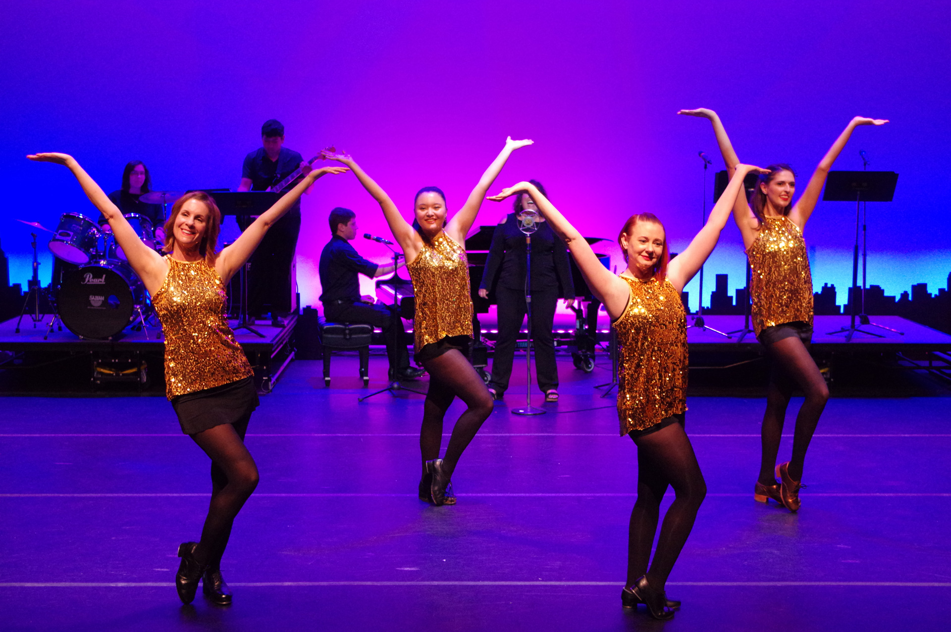 Patel students on stage performing a dance routine.