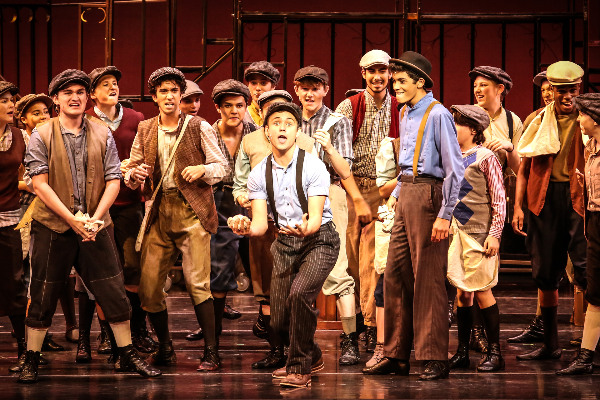 Patel students on stage in 1920s period costume performing a musical.